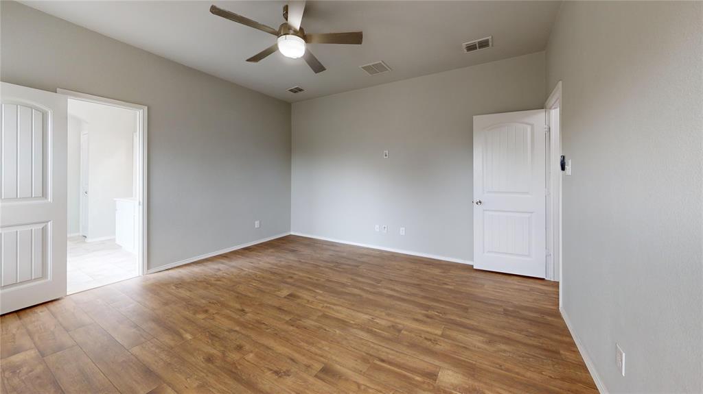 3101 Buckthorn Street Forney, TX 75126 - Photo 27 of 40 Spacious room featuring wood-finish flooring, light gray walls, white trim, and a ceiling fan with integrated lighting