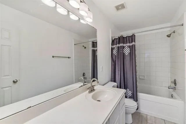 a view of a bedroom with a bed and a window