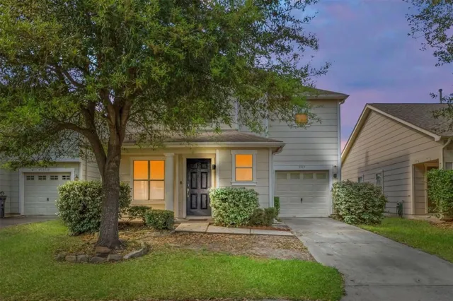 a front view of a house with a garden and plants