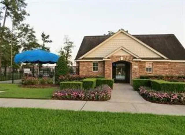 a view of a patio with a table chairs and a floor to ceiling window
