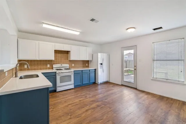 a kitchen with stainless steel appliances granite countertop a refrigerator sink and cabinets