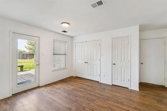 a view of a kitchen cabinets and wooden floor