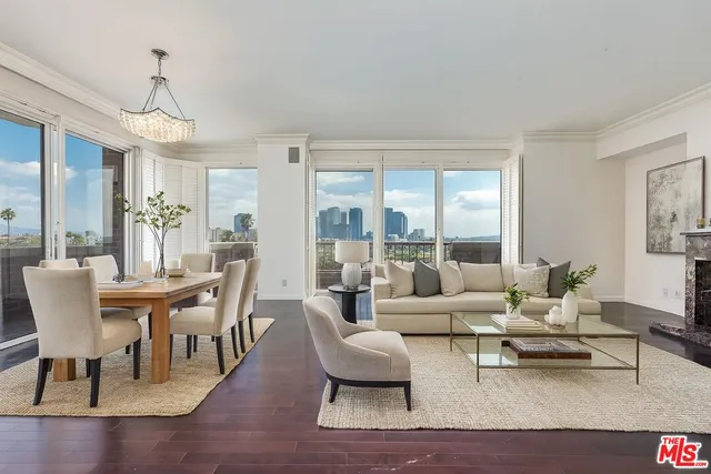 a living room with furniture wooden floor and a chandelier