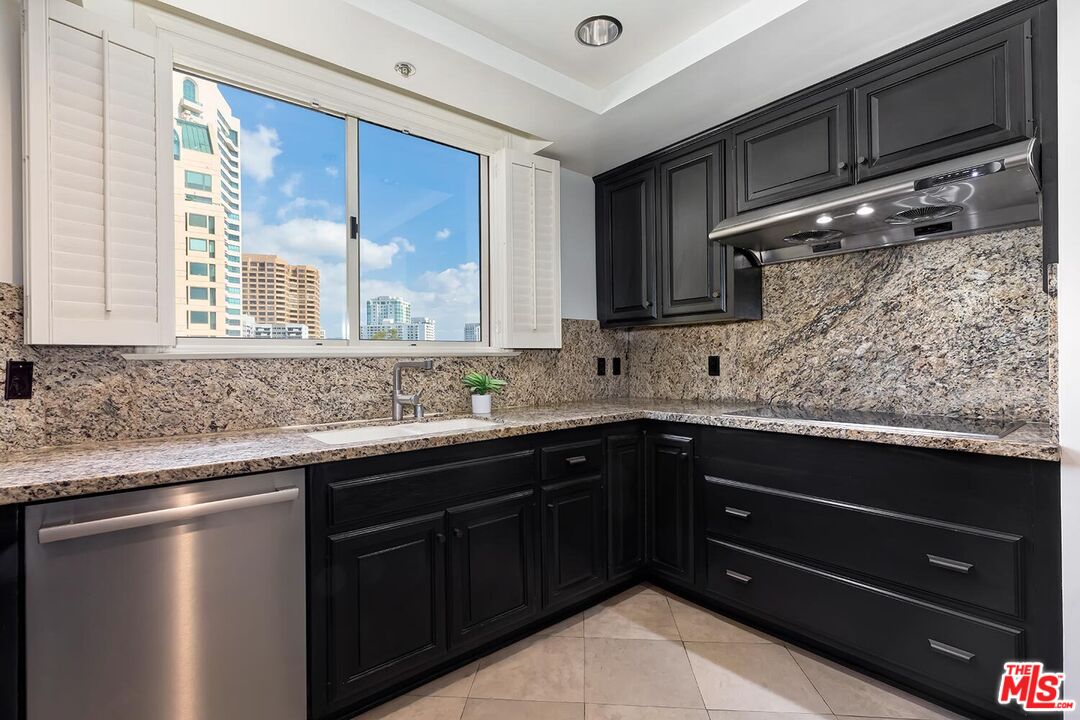 10550 Wilshire Boulevard, Unit 804 Los Angeles, CA 90024 - Photo 13 of 22 a kitchen with a sink and wooden cabinets