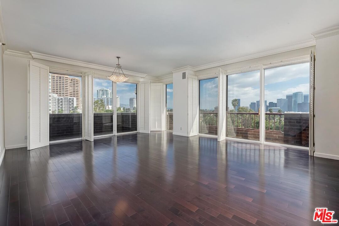 10550 Wilshire Boulevard, Unit 804 Los Angeles, CA 90024 - Photo 15 of 22 an empty room with wooden floor and windows