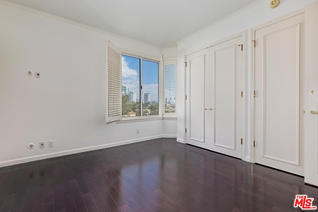 10550 Wilshire Boulevard, Unit 804 Los Angeles, CA 90024 - Photo 18 of 22 a view of an empty room with wooden floor and a window