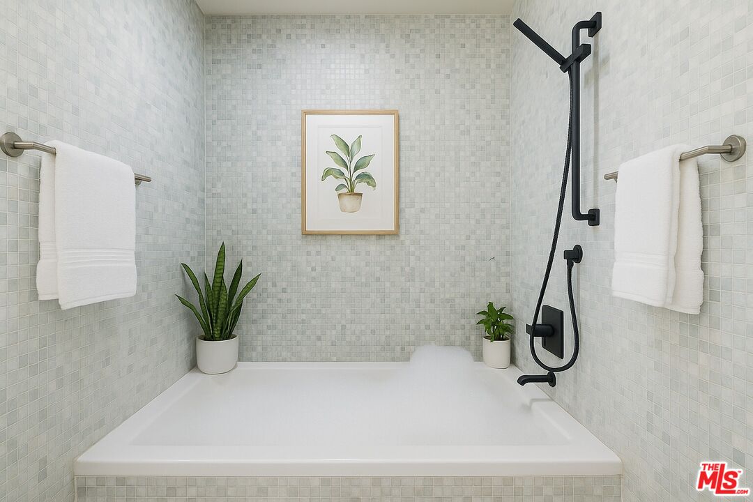10550 Wilshire Boulevard, Unit 804 Los Angeles, CA 90024 - Photo 6 of 22 a white bath tub sitting in a bathroom