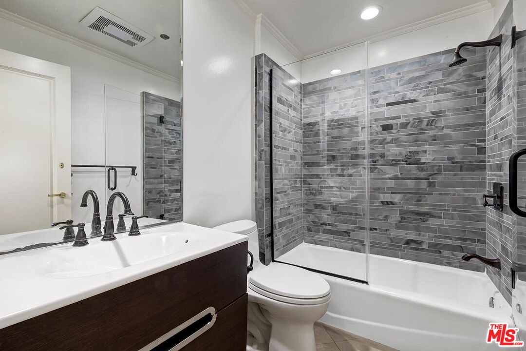 10550 Wilshire Boulevard, Unit 804 Los Angeles, CA 90024 - Photo 9 of 22 a bathroom with a sink a toilet and shower