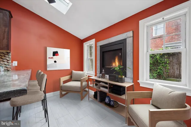 a living room with furniture a flat screen tv and a window