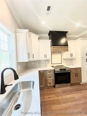 a kitchen with a sink cabinets and window