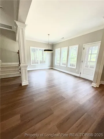a view hallway and an empty room with wooden floor