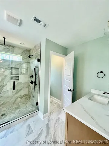 a spacious bathroom with a tub sink and mirror