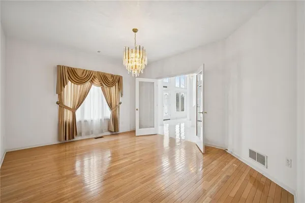 a view of entryway and hall with a living room