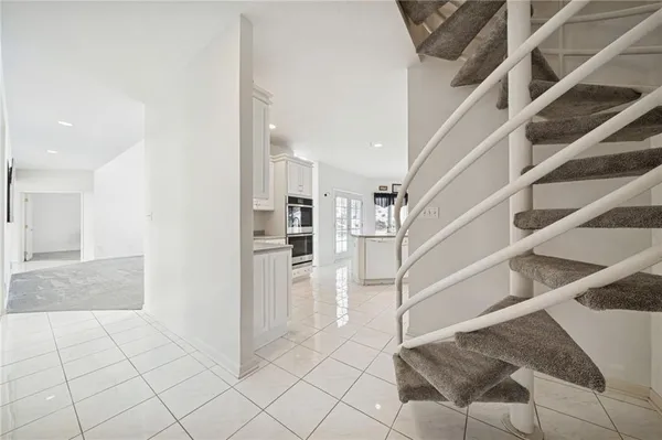 a kitchen with granite countertop white cabinets stainless steel appliances and sink