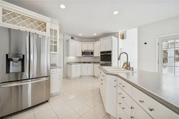 a view of kitchen with furniture and refrigerator