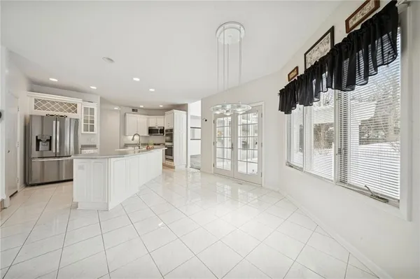 an empty room with windows and fireplace