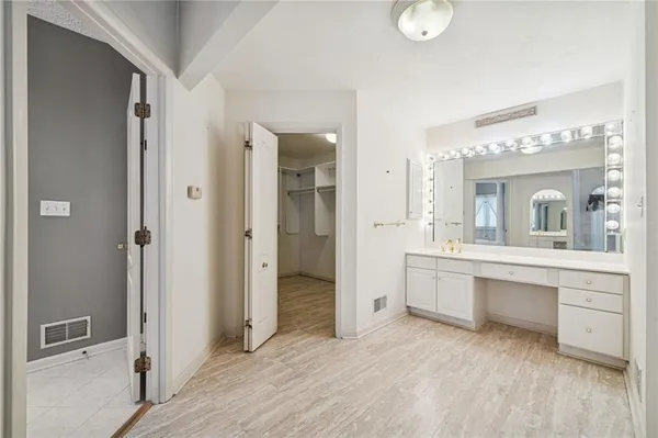 a spacious bathroom with a tub sink shower and mirror
