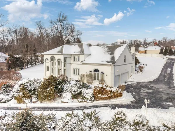 a view of a house with a yard covered with snow
