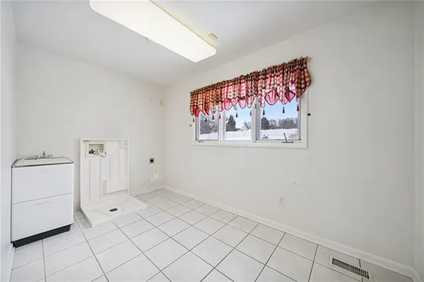 a view of a livingroom with an empty space and a window