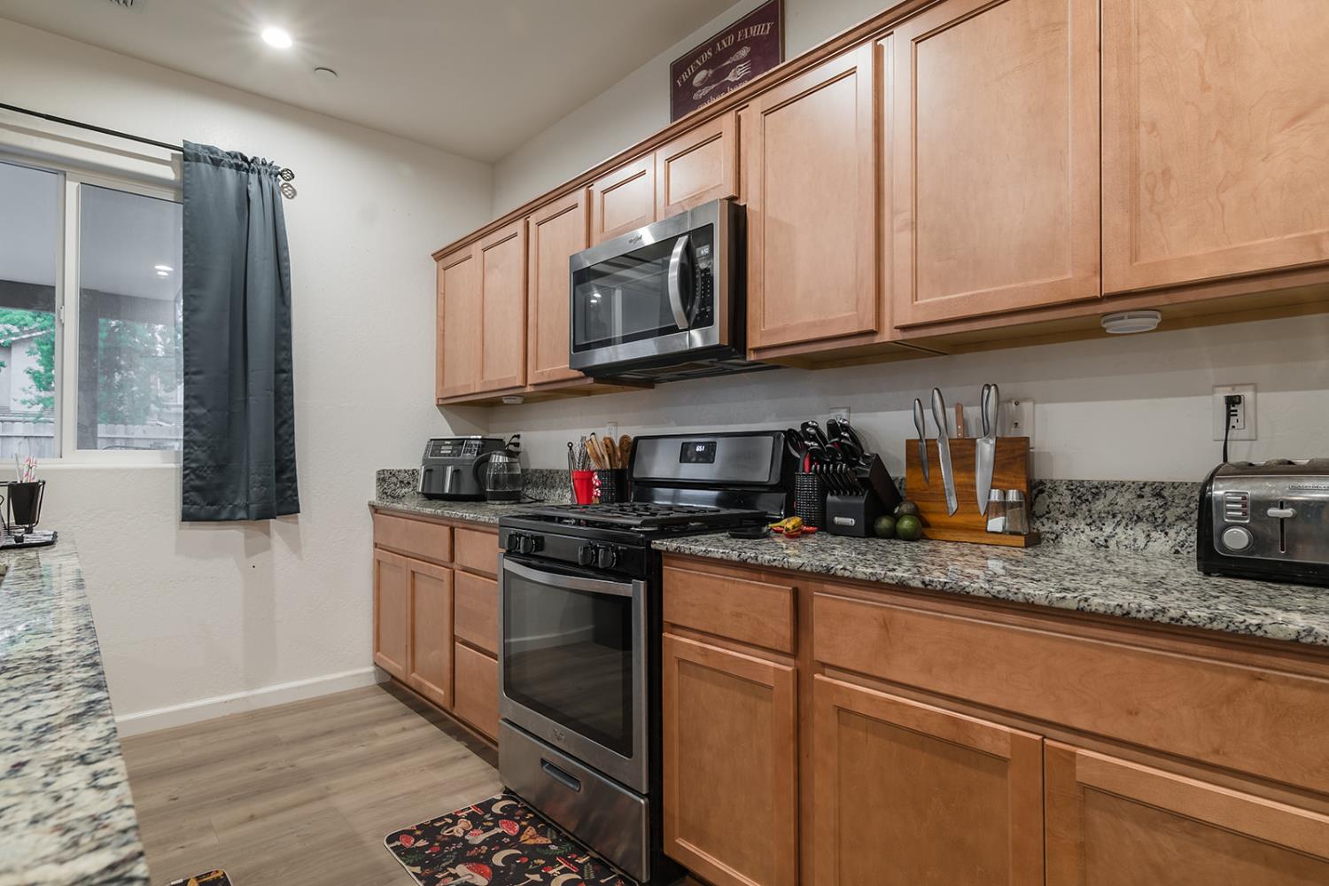 1945 East Gum Avenue Reedley, CA 93654 - Photo 11 of 31 a kitchen with stainless steel appliances granite countertop a sink stove and microwave