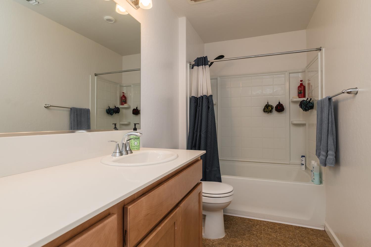 1945 East Gum Avenue Reedley, CA 93654 - Photo 24 of 31 a bathroom with a sink a toilet and shower