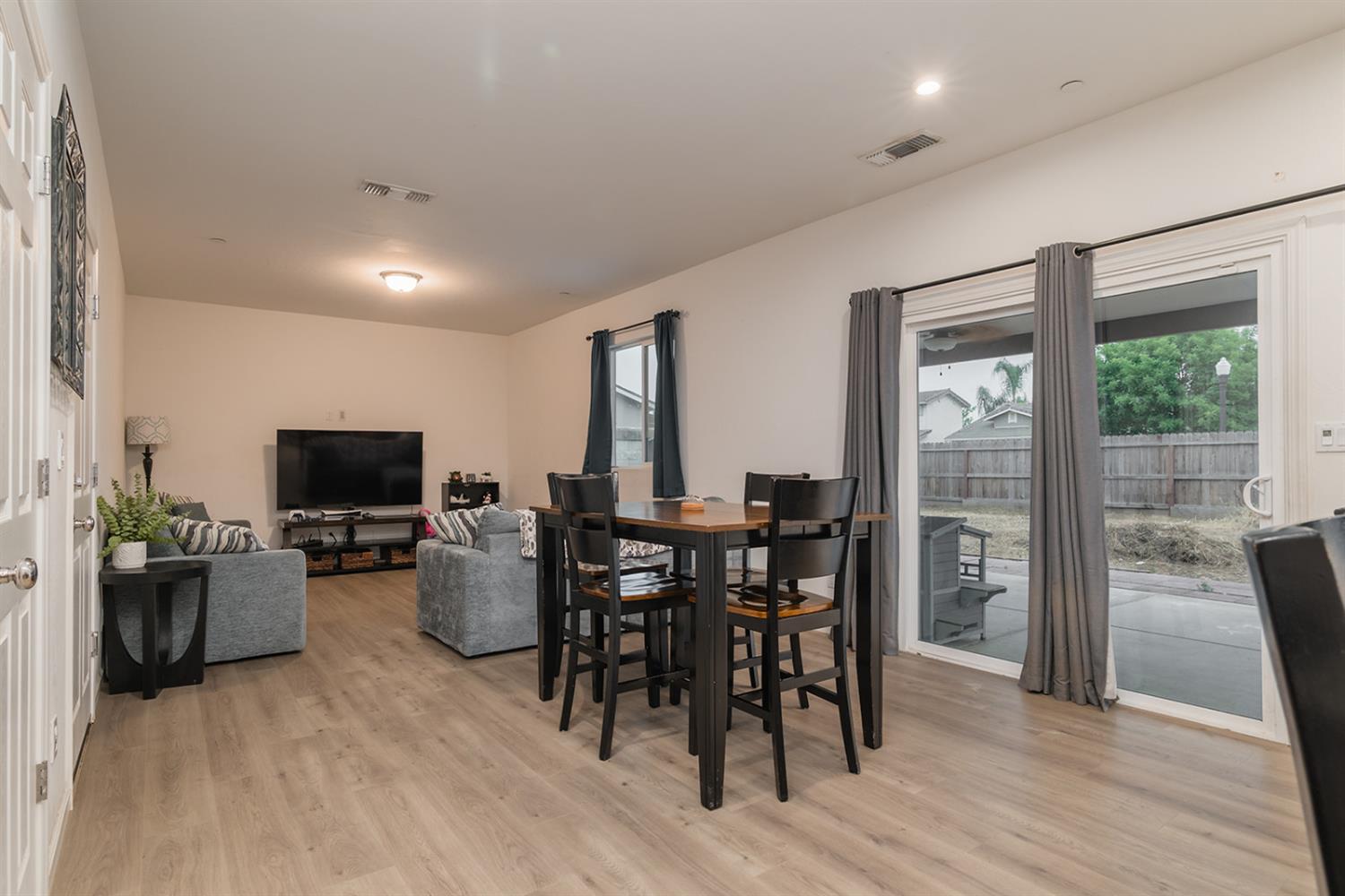 1945 East Gum Avenue Reedley, CA 93654 - Photo 7 of 31 a view of a dining room with furniture window and wooden floor