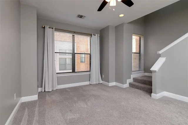 a view of an empty room with a fireplace and a window
