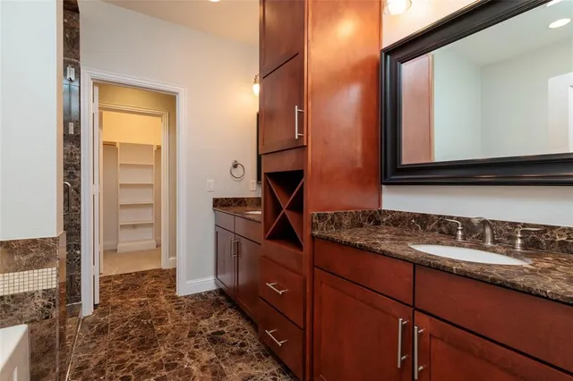 a kitchen with sink and cabinets