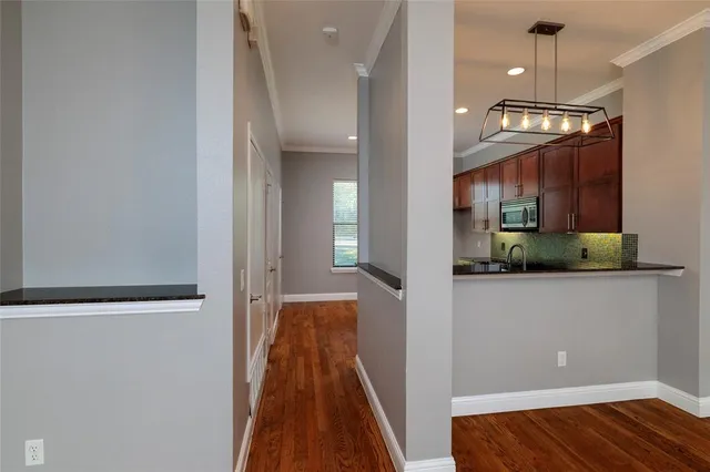 a view of a hallway with wooden floor and staircase