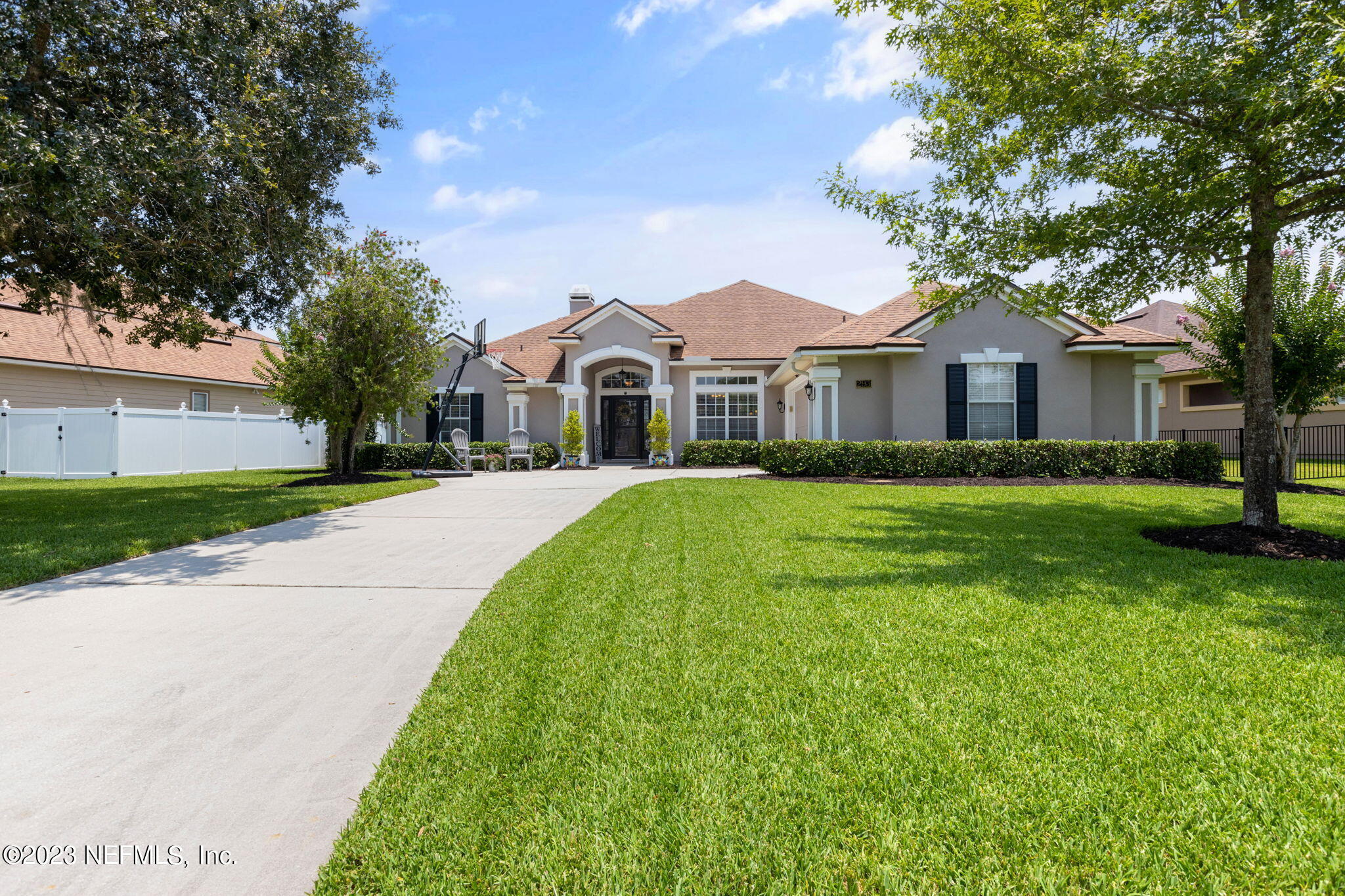 293 Porta Rosa Circle St. Augustine, FL 32092 - Photo 1 of 37 a front view of a house with a garden and trees