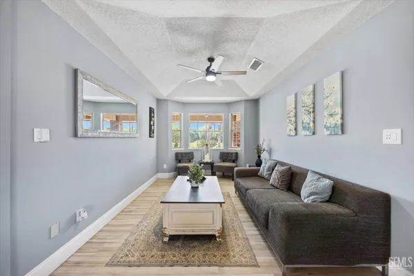 a kitchen with kitchen island a counter top space a sink cabinets and stainless steel appliances