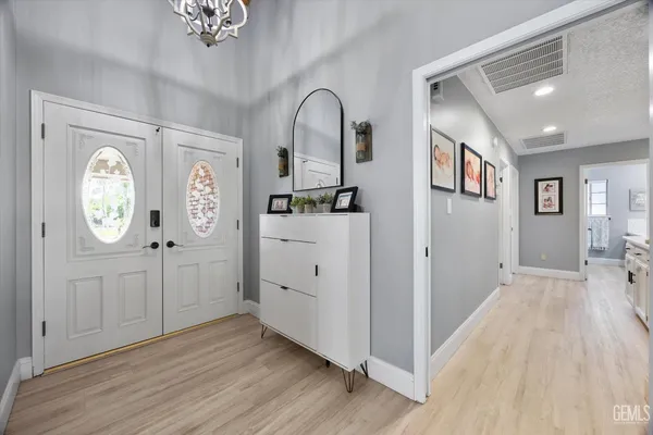 a spacious bedroom with a bed and a large window