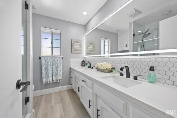 a kitchen with cabinets a sink and wooden floor