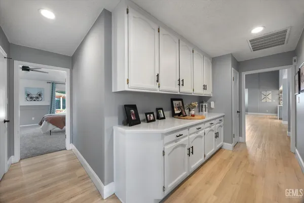 a spacious bathroom with a double vanity sink mirror and bathtub
