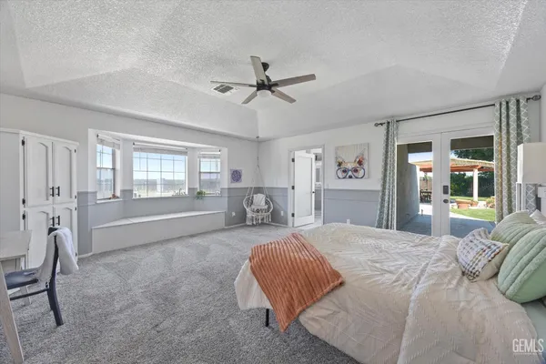 a bedroom with a large bed and a couch