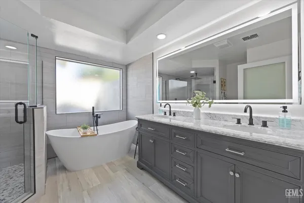 a white bath tub sitting next to a bathroom