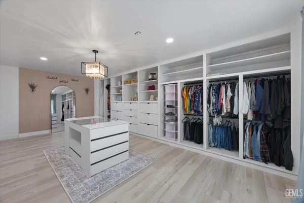 a kitchen with stainless steel appliances granite countertop a sink a stove a refrigerator cabinets and living room view