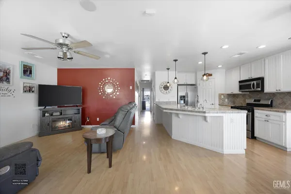 a spacious bedroom with a bed and a chandelier