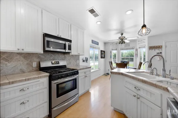 a bathroom with a double vanity sink mirror and toilet