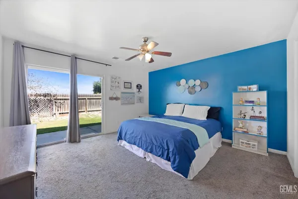 a view of backyard with table and chairs and potted plants