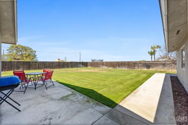 a swimming pool with outdoor seating and yard