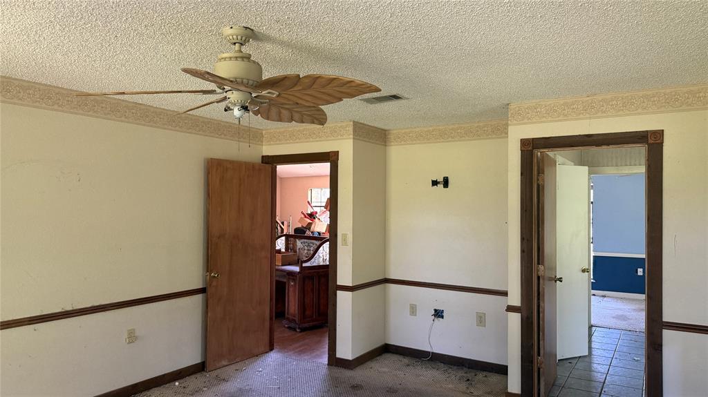 6582 Taylor Road Kaufman, TX 75142 - Photo 28 of 40 a view of a hallway with closet and a chandelier fan