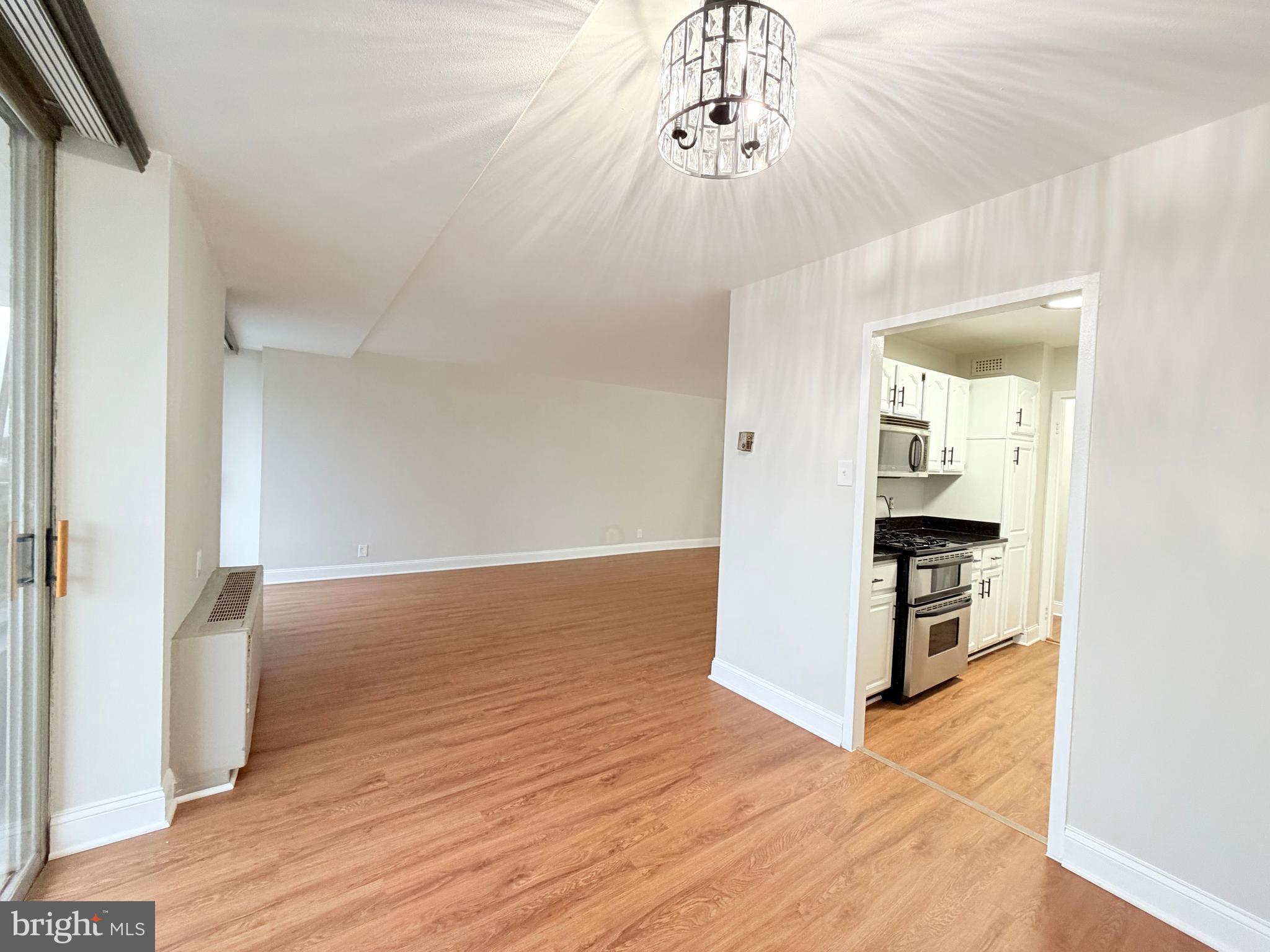 301 North Beauregard Street, Unit 703 Alexandria, VA 22312 - Photo 3 of 16 wooden floor in an empty room with a chandelier