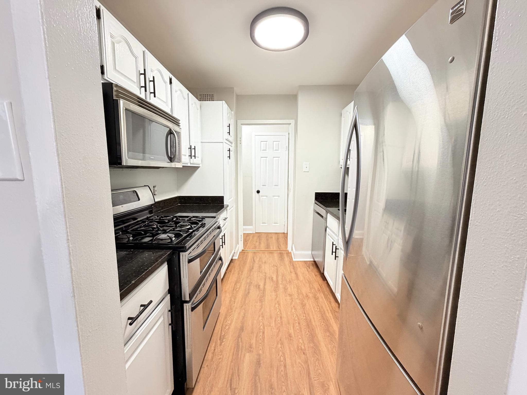301 North Beauregard Street, Unit 703 Alexandria, VA 22312 - Photo 5 of 16 a kitchen with stainless steel appliances granite countertop a refrigerator and a stove