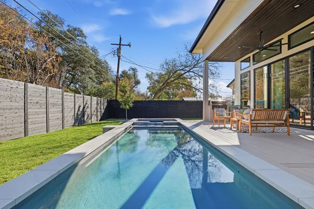 a bathroom with a granite countertop sink a toilet and shower