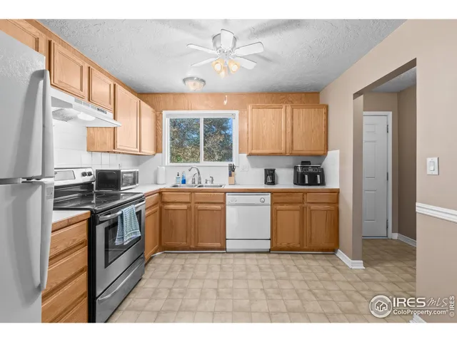 a kitchen with a stove a sink and a microwave