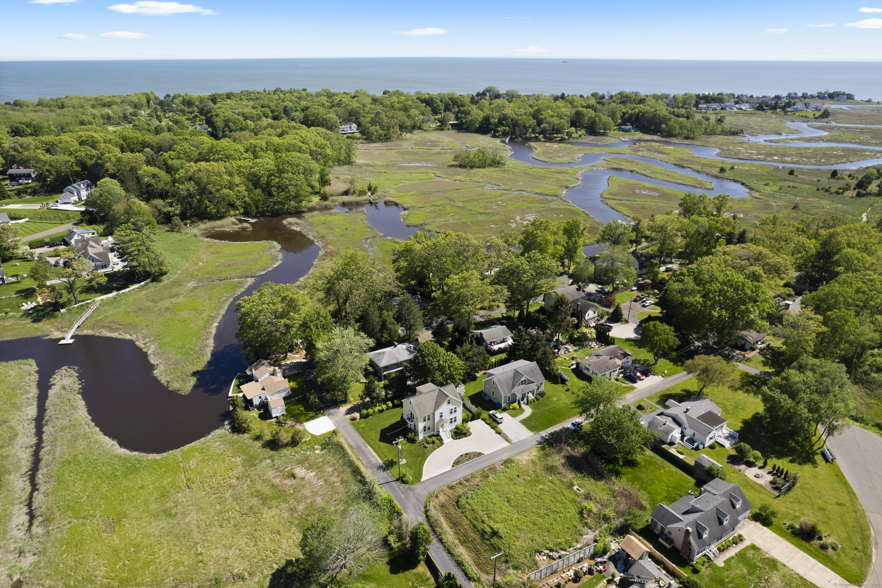 3 Arrowhead Road Madison, CT 06443 - Photo 1 of 40 a view of a lake with a yard and mountain view in back