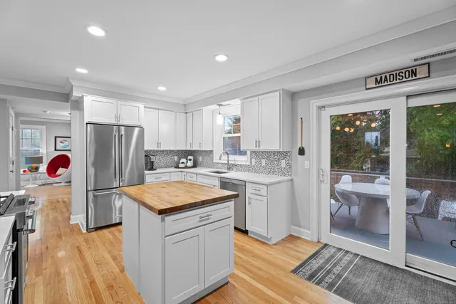 a kitchen with refrigerator cabinets and wooden floor