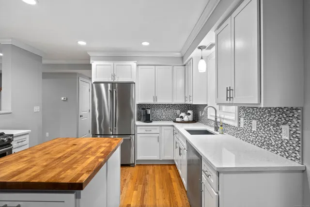 a kitchen with a sink a stove and cabinets
