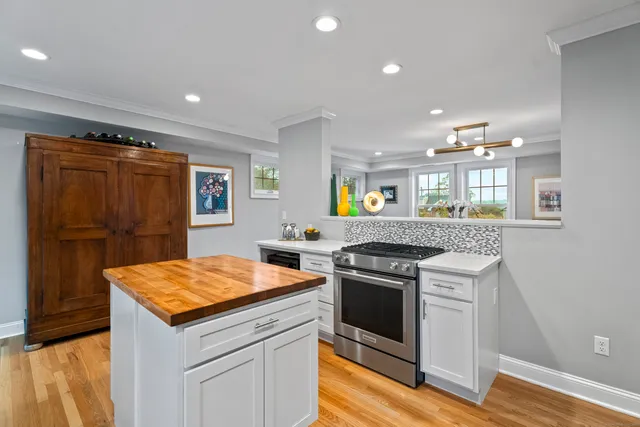 a kitchen with a stove a sink and a refrigerator